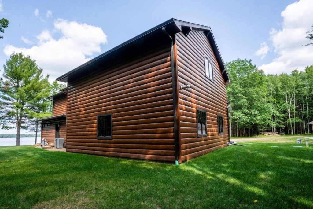 A home featuring TruLog's steel log siding, a durable faux wood siding option