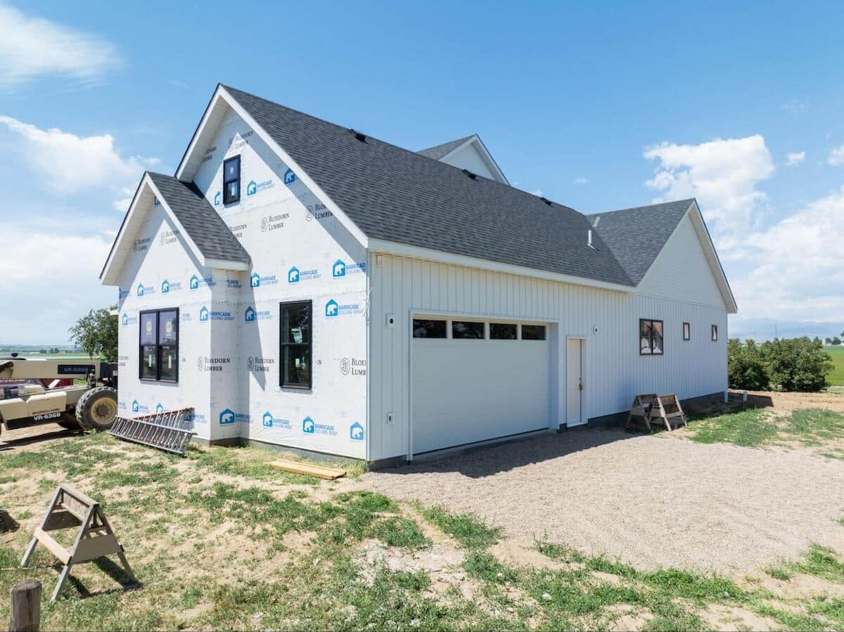 TruLog steel board and batten siding being installed on a home