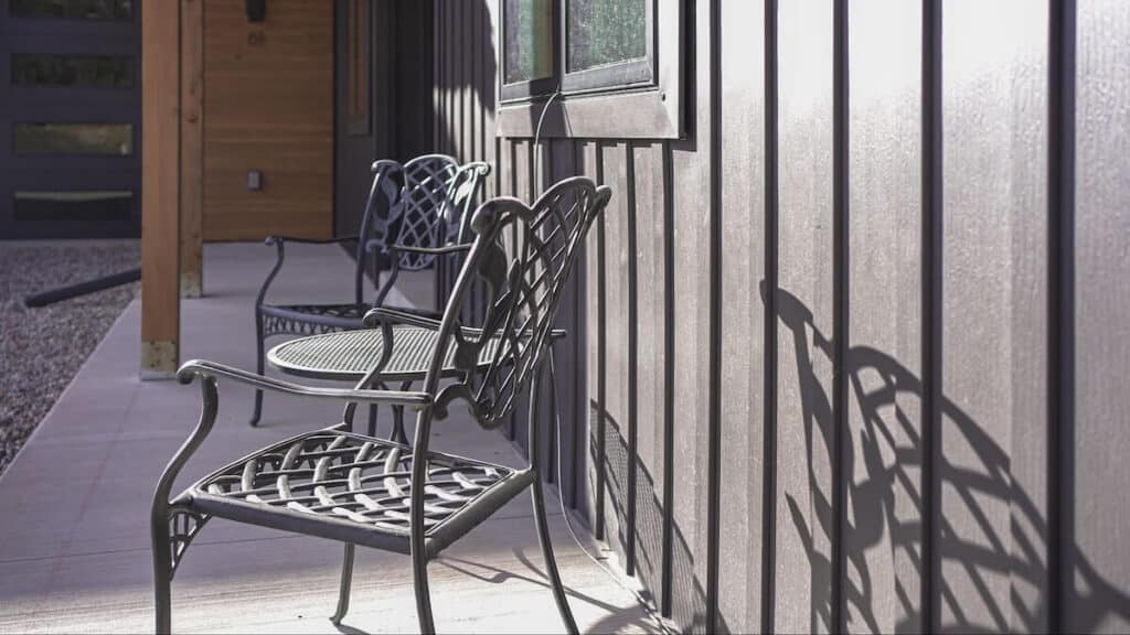 A closeup of TruLog steel board and batten siding on the exterior wall of a home