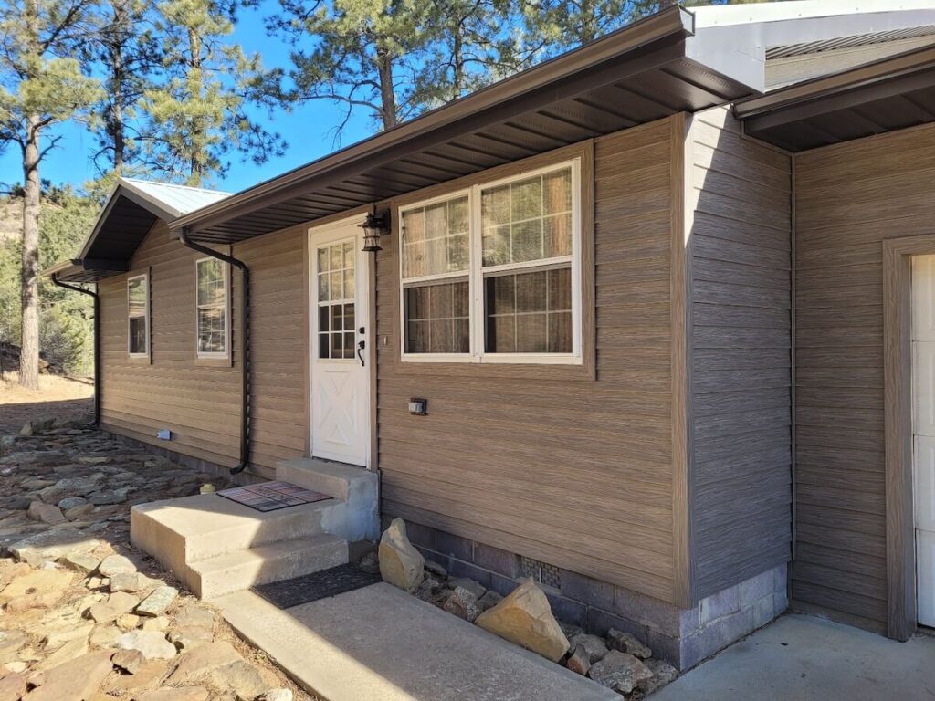 The front of a ranch-style home with TruLog steel lap siding in Driftwood
