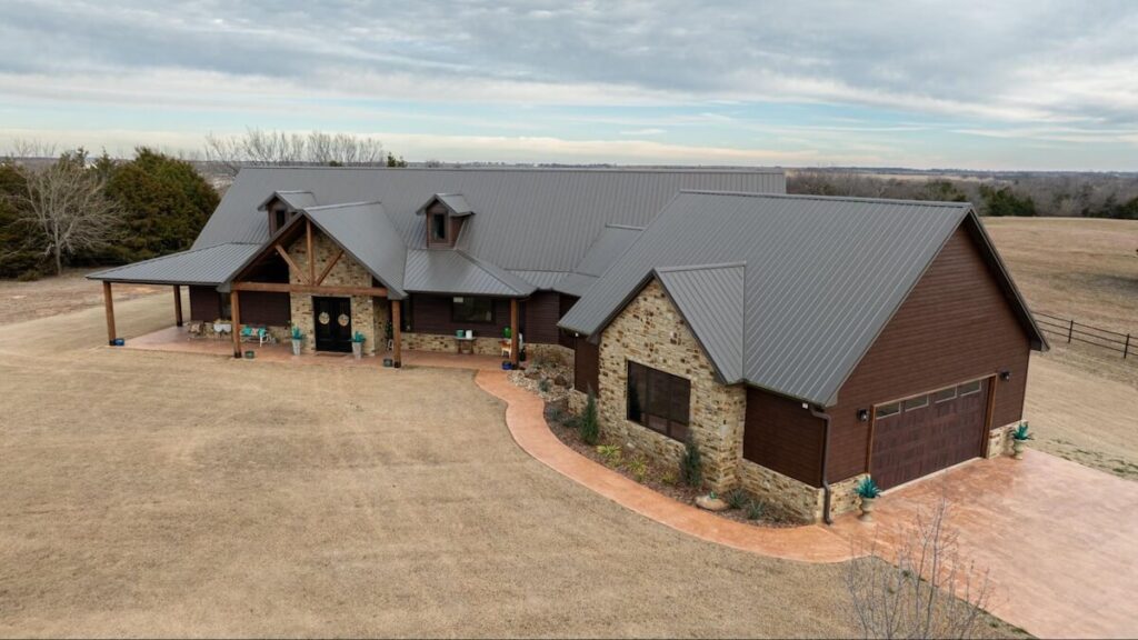 An aerial view of a home with a mix of TruLog steel lap siding and brick